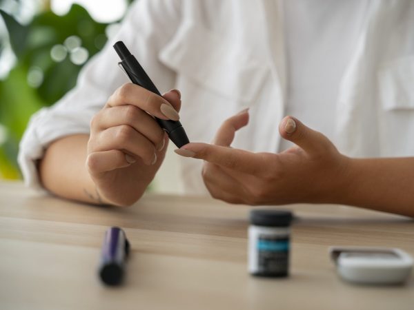 front-view-diabetic-woman-checking-her-glucose-level-min