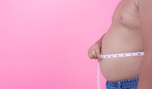 obese-boy-who-is-overweight-pink-background-min