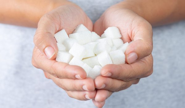 world-diabetes-day-hand-holding-sugar-cubes-min